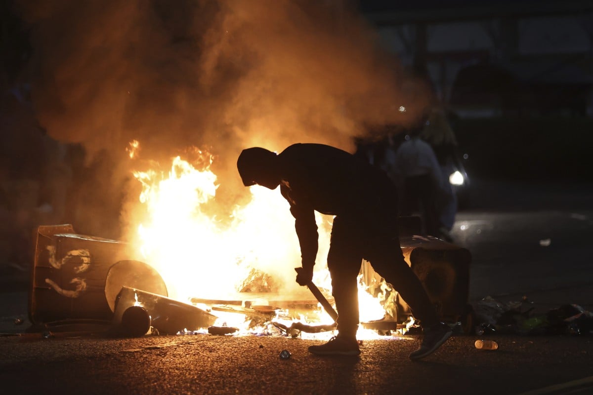 A protester stokes a barricade fire in Ballymena, Northern Ireland on Wednesday, June 11, 2025. Photo: AP Photo