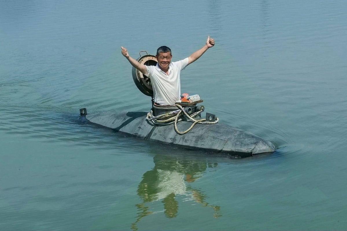 Chinese farmer Zhang Shengwu poses in his homemade submarine in a river in Hanshan county, in China’s eastern Anhui province. Photo: AFP