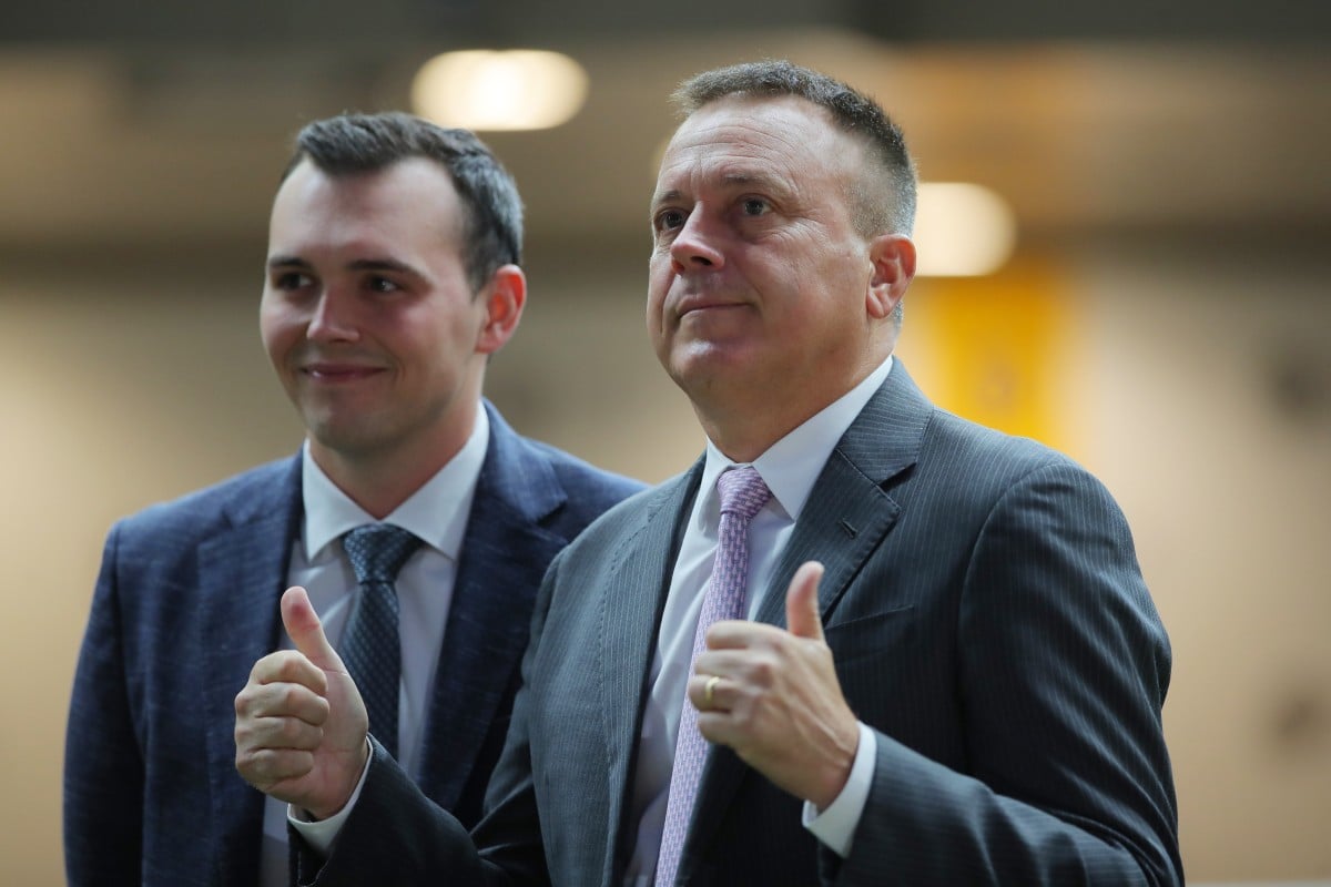 Caspar Fownes (right) and son Ronan celebrate the stable’s latest treble at the Valley. Photos: Kenneth Chan