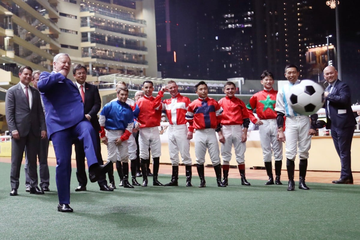 Jockeys watch on as Jockey Club chief executive Winfried Engelbrecht-Bresges (left) shoots for goal before the "Eight To Glory" race at Happy Valley. Photos: Kenneth Chan