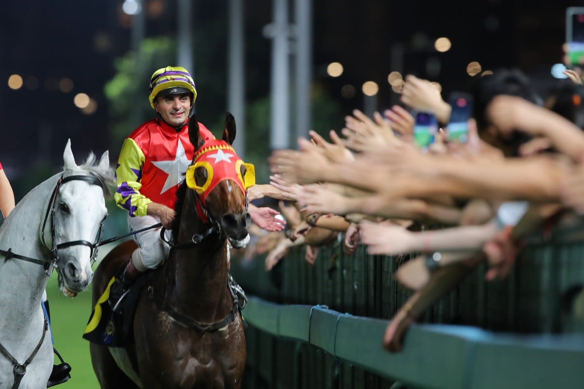 Andrea Atzeni celebrates his win on Crimson Flash last season with the Happy Valley crowd. Photos: Kenneth Chan