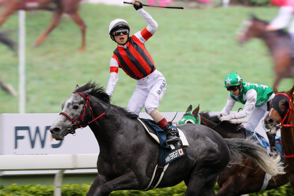 Jockey Masami Matsuoka celebrates the win aboard Win Bright in the Group One QE II Cup (2,000m) at Sha Tin on Sunday.