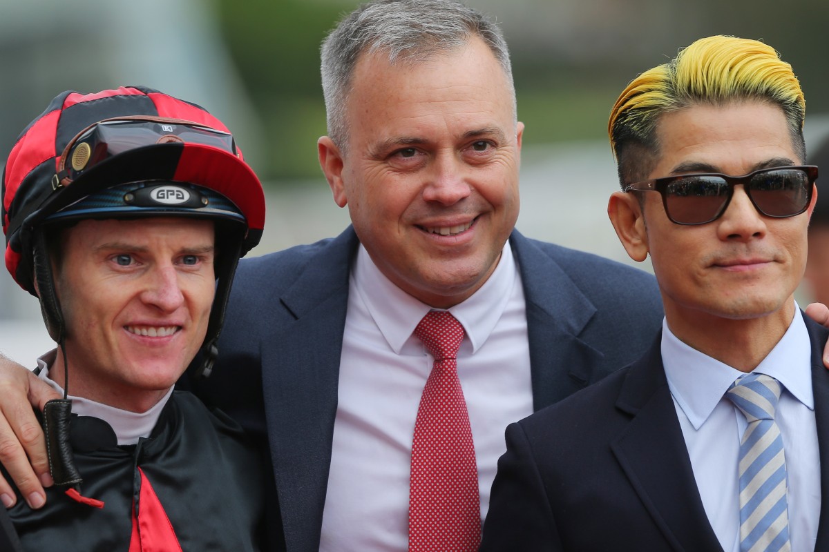 Trainer Caspar Fownes (middle) celebrates the win of Dancing Fighter with jockey Zac Purton (left) and Canto-pop superstar Aaron Kwok (right). Photos: Kenneth Chan