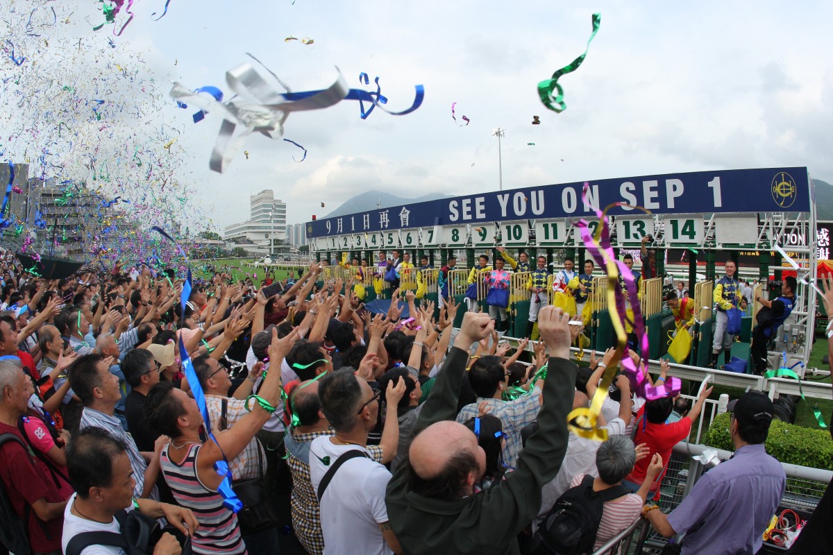 Jockeys throw toys to the fans after the season finale at Sha Tin on Sunday. Photos: Kenneth Chan
