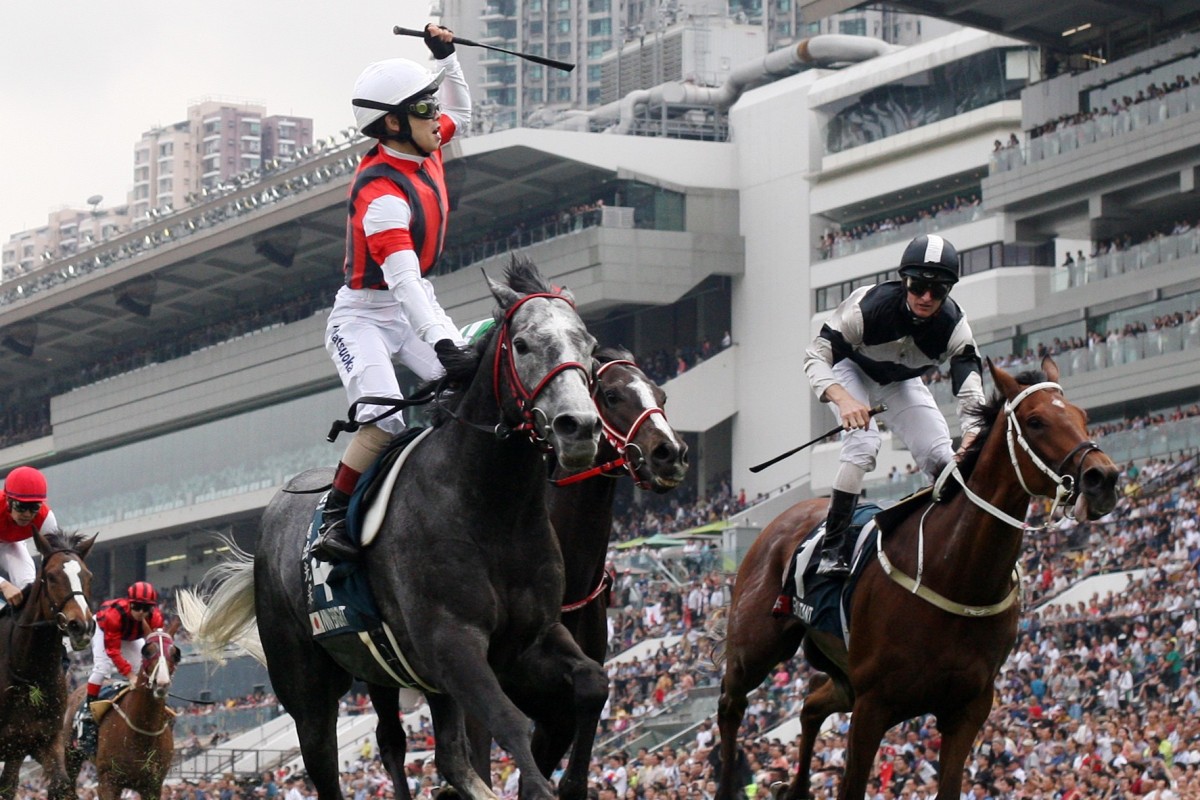 Masami Matsuoka stands and delivers a celebration to remember after winning the QEII Cup at Sha Tin. Photos: Kenneth Chan