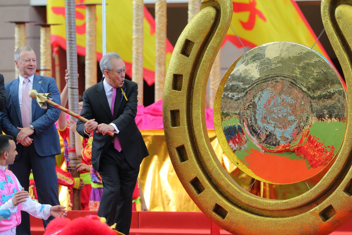 Hong Kong Jockey Club chairman Anthony Chow opens the racing season by striking a gong at Sha Tin. Photos: Kenneth Chan
