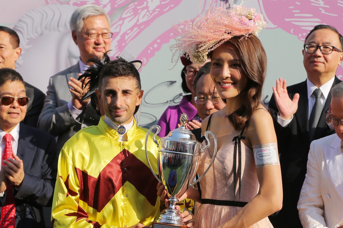 Kelly Cheung presents the trophy to winning jockey Alberto Sanna. Photos: Kenneth Chan