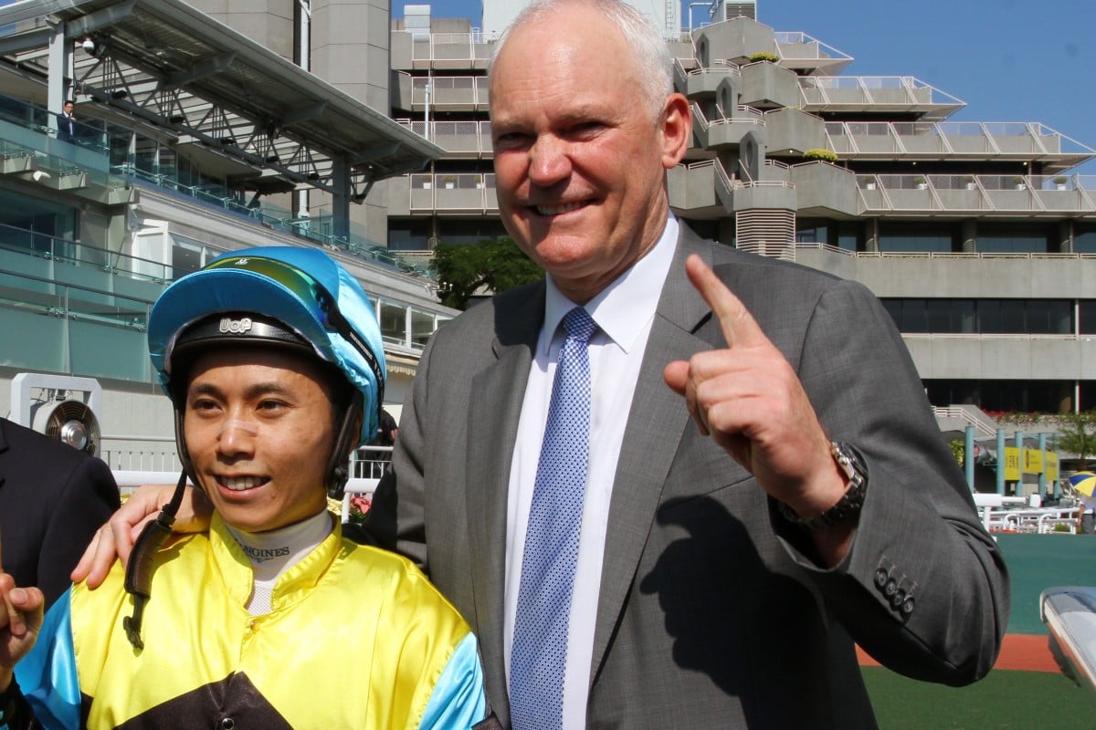 Matthew Poon celebrates with trainer David Hall after his 100th Hong Kong winner. Photos: Kenneth Chan