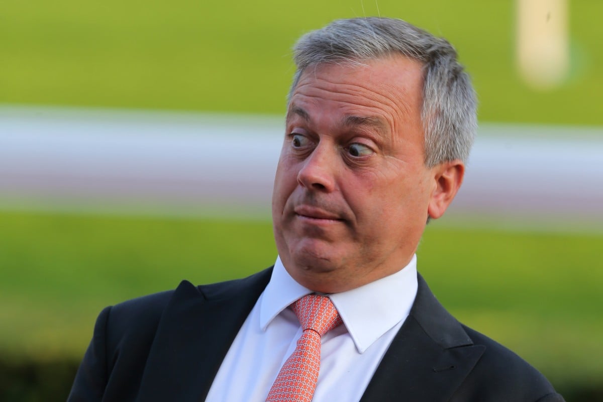Trainer Caspar Fownes plays up for the cameras after winning with Enfolding at Sha Tin on Sunday. Photo: Kenneth Chan