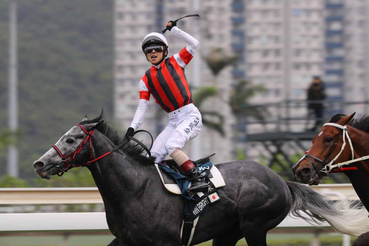 Jockey Masami Matsuoka salutes as Win Bright wins the QE II Cup. Photos: Kenneth Chan