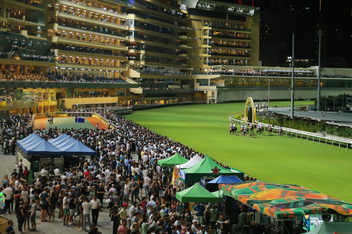 Punters in the beer garden watch the races at Happy Valley. Photo: Kenneth Chan