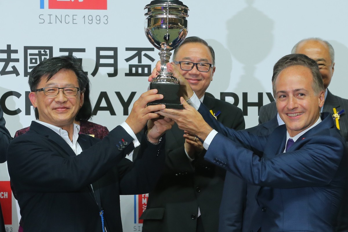 Junius Ho Kwan-yiu (left) collects a trophy after Hong Kong Bet wins at Happy Valley in May. Photos: Kenneth Chan