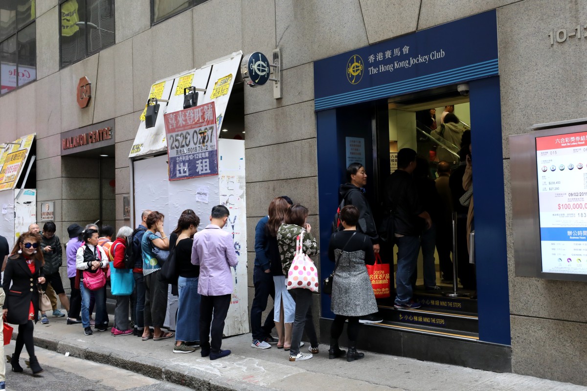 Gamblers line up at a Hong Kong Jockey Club off-course betting branch in Central. Photo: SCMP/Dickson Lee