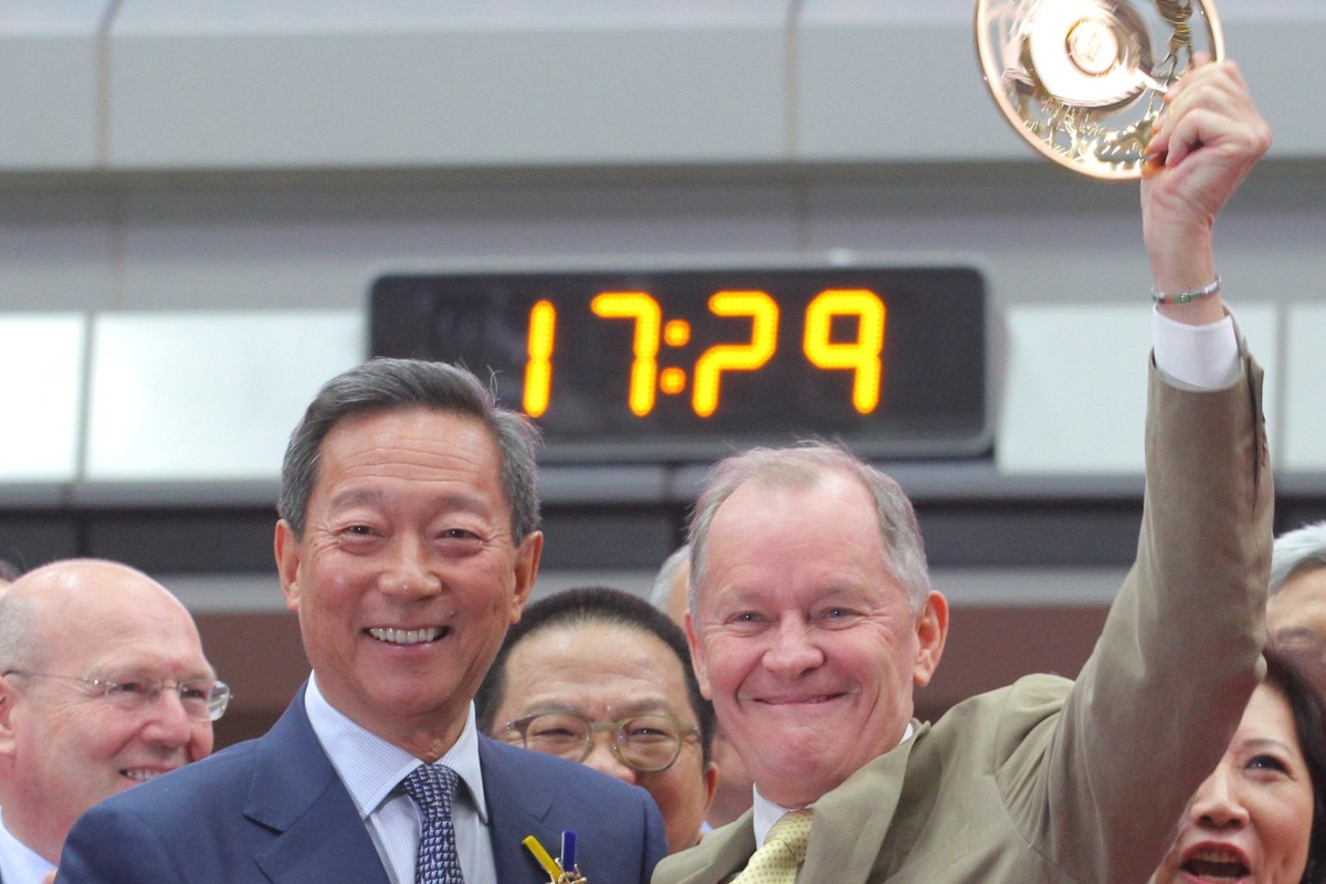 Former Jockey Club chairman Simon Ip presents trainer John Moore with the 2016 Hong Kong Derby spoils after his victory with Werther. Photos: Kenneth Chan