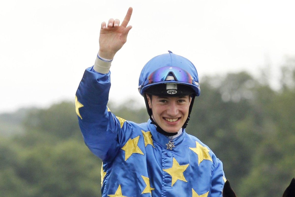 French jockey Antoine Hamelin celebrates after winning the Group One Prix du Jockey Club with Saonois. Photo: AFP