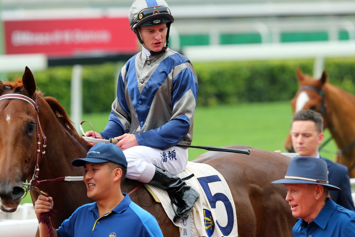 John Moore and Zac Purton discuss the Griffin win of Aethero last season. Photos: Kenneth Chan