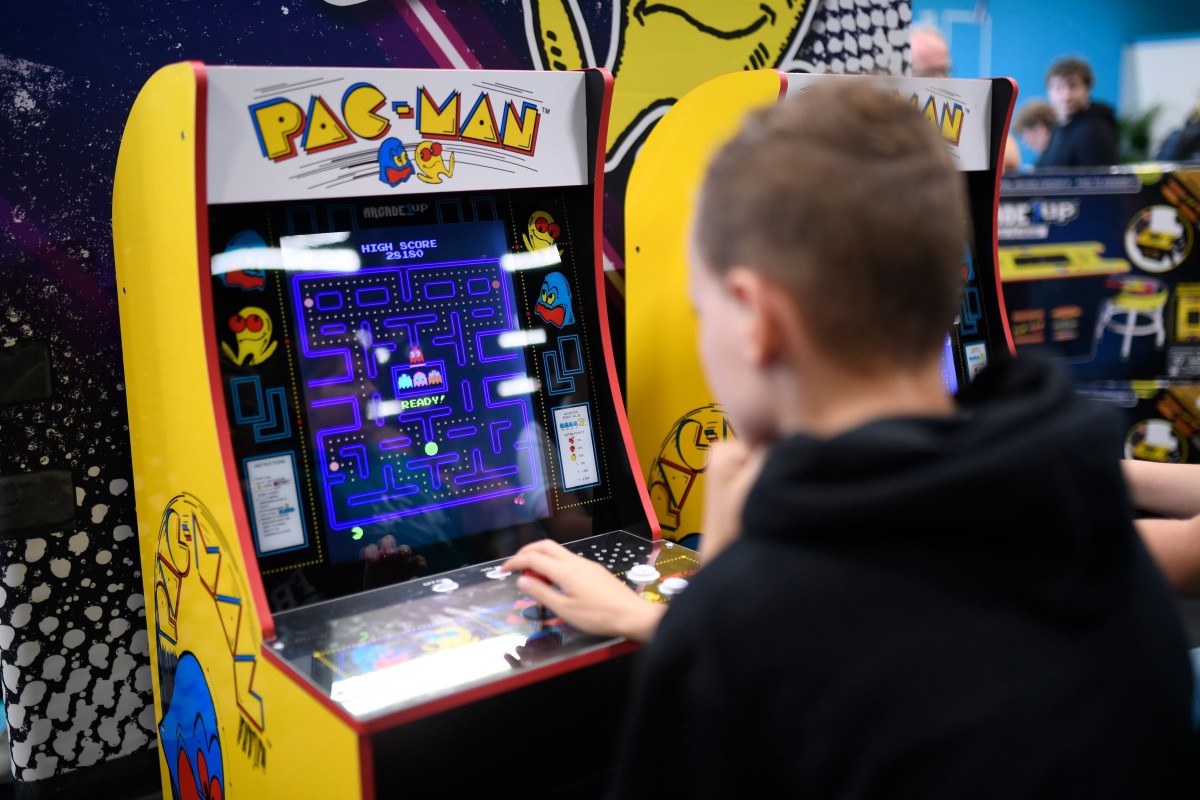 A boy plays the "Pacman" retro game at the Video games trade fair Gamescom in Cologne, western Germany, on August 21, 2019.