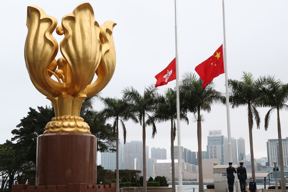 Paying respect to those killed by the coronavirus pandemic, the Hong Kong SAR and the flag of China are lowered half-mast during a ceremony at the Golden Bauhinia Square, Wan Chai.