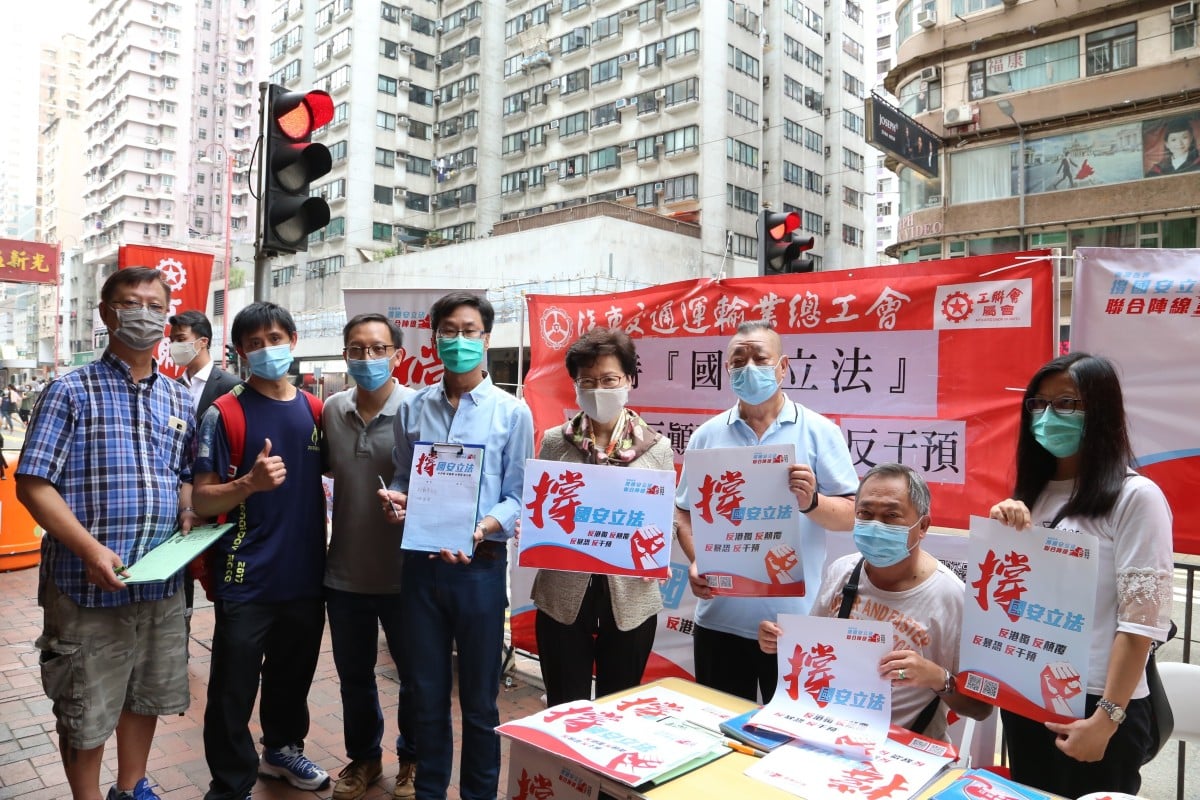 Chief Executive of the Hong Kong Special Administrative Region (HKSAR) Carrie Lam visits a street stand and signs a petition in support of the national security legislation in Hong Kong. (Xinhua)