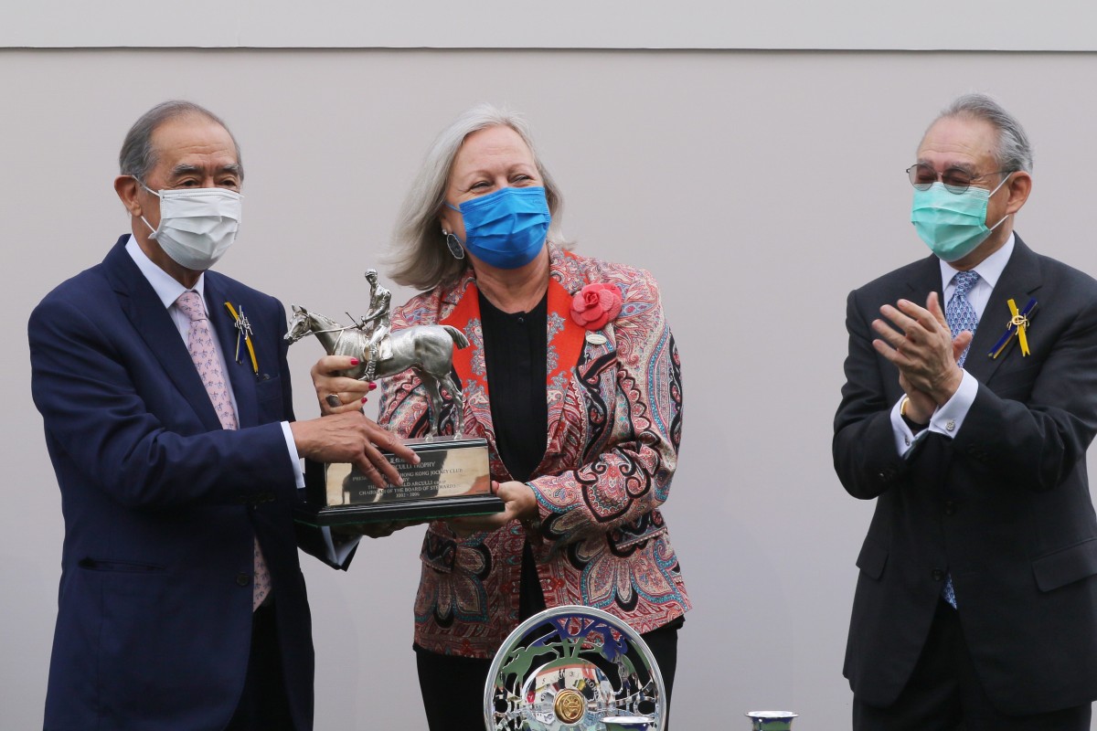 Ronald Arculli accepts the spoils for the Arculli Trophy from wife Johanna at Sha Tin on Sunday. Photos: Kenneth Chan