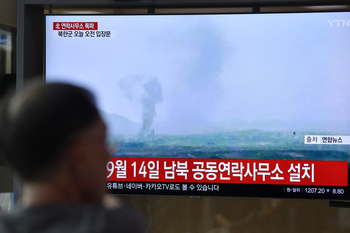 People watch a television news screen showing an explosion of an inter-Korean liaison office in North Korea's Kaesong Industrial Complex, at a railway station in Seoul. (Photo by Jung Yeon-je / AFP)