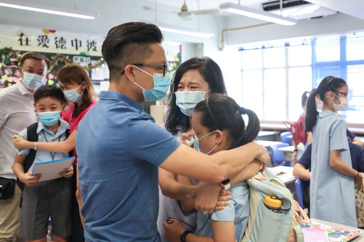 Ellie Wong Lok-tung, 11, and her parents got very emotional when they found out Ellie had been allocated to a school of her first choice at True Light Girls' College. About 90 per cent of students got into one of their top three picks. (Photo: SCMP / Xiaomei Chen)