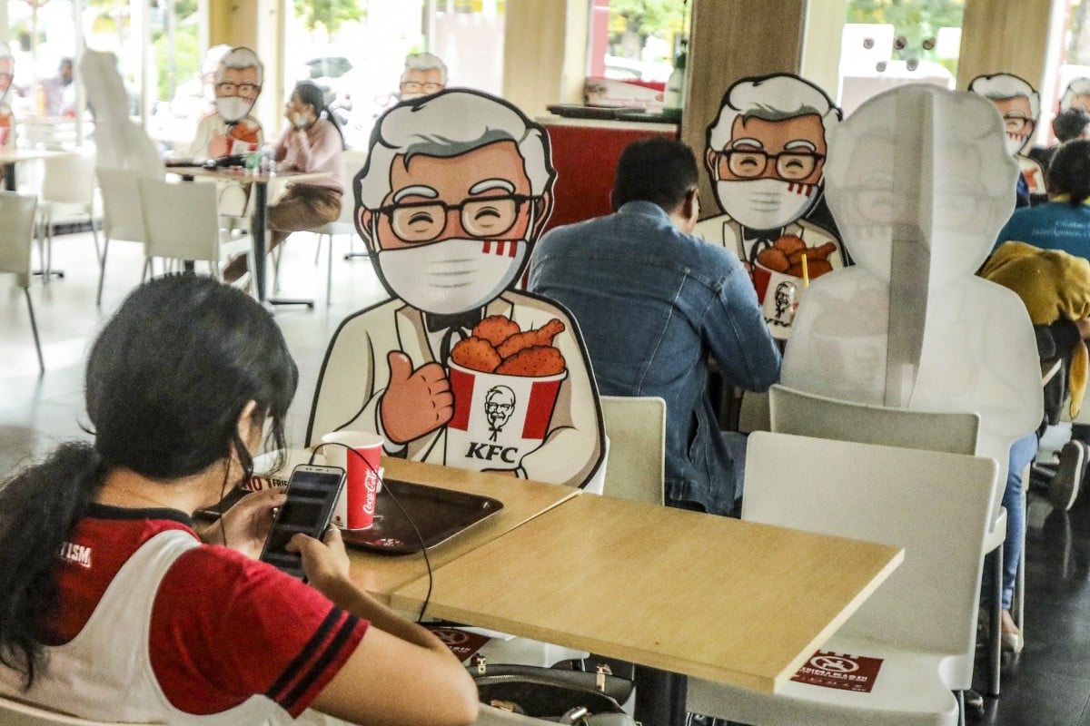 The Colonel is all masked up, but maybe he needs those plastic gloves, too. Photo: EPA-EFE
