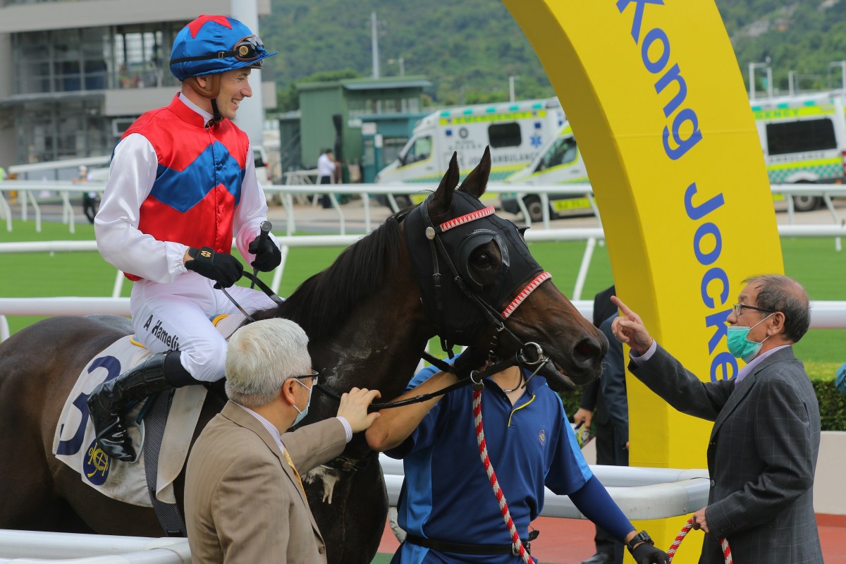 Winwin Thirtythree’s owner give the horse a pat after winning at Sha Tin on Sunday. Photos: Kenneth Chan