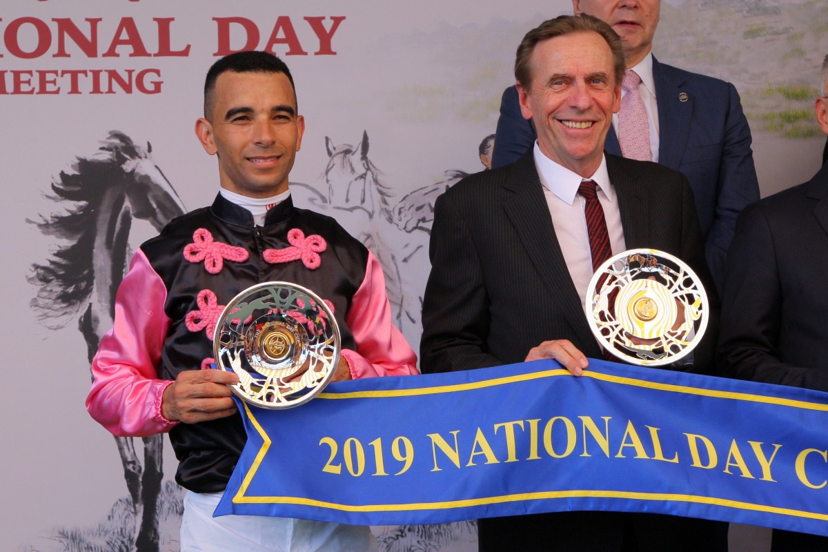 Joao Moreira and John Size pose for photos with their trophies after winning the 2019 National Day Cup with Full Of Beauty. Photos: Kenneth Chan