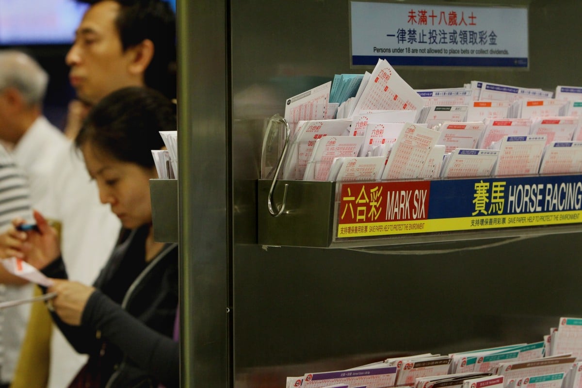 People queue to bet at a Jockey Club branch. Photo: SCMP