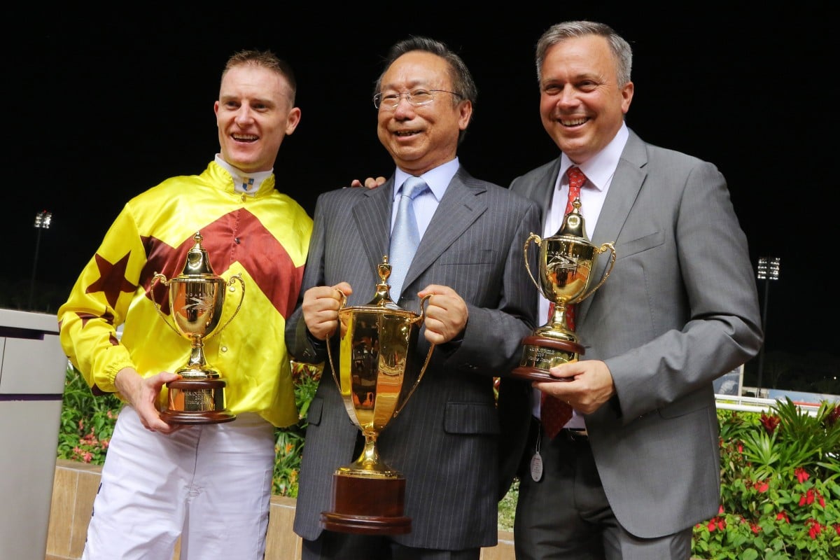 Jockey Zac Purton, owner Boniface Ho and trainer Caspar Fownes (right) enjoy Southern Legend’s second Kranji Mile victory. Photo: Kenneth Chan