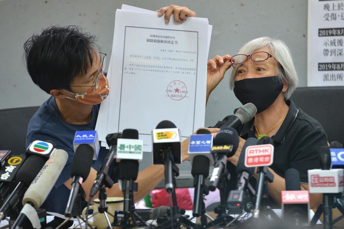 64-year-old pro-democracy protester Alexandra Wong (R) shows a Chinese public security document to the media with supporter Eddie Chu (L) at a press conference in Hong Kong on October 17, 2020. Photo: AFP