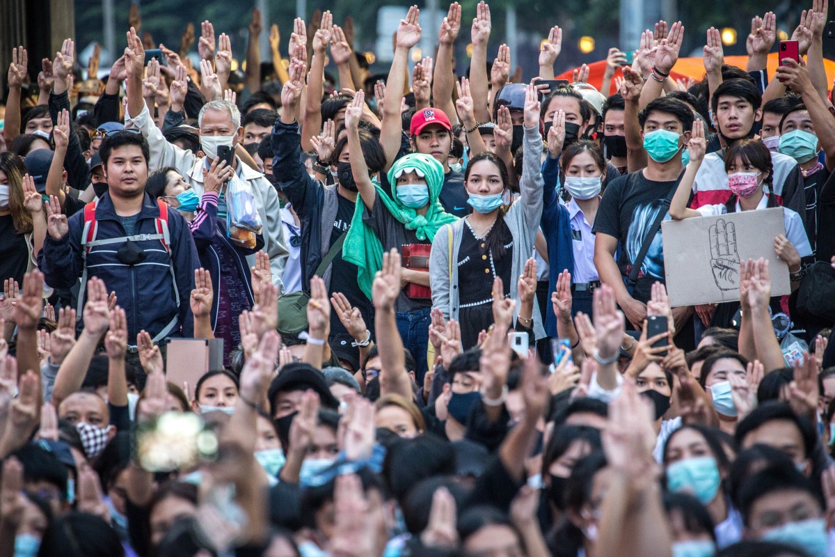 Pro-democracy protestors in Bangkok give the three-finger salute. Photo: DPA