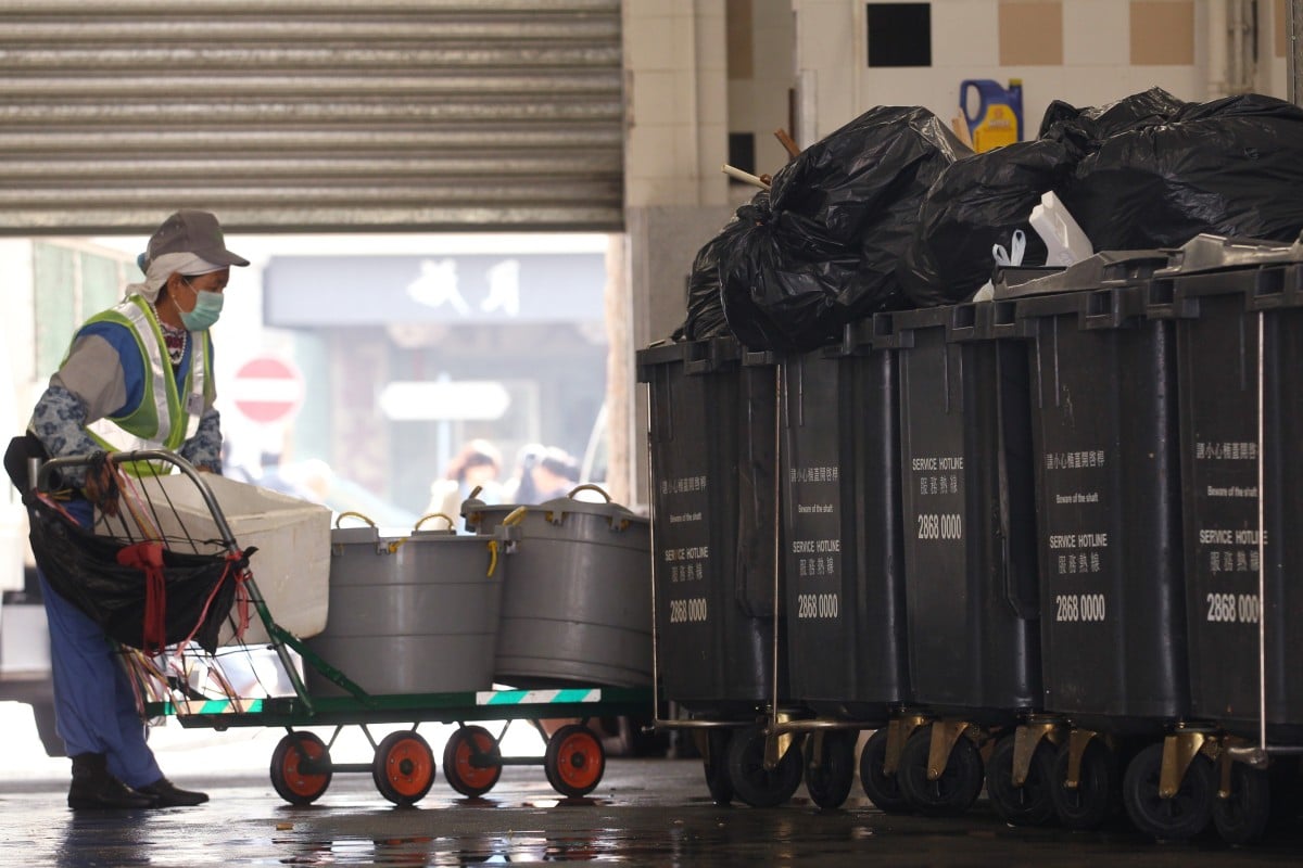 Workers are often forced to sit, rest and eat in close proximity of the garbage they have collected. Photo: SCMP/Nora Tam
