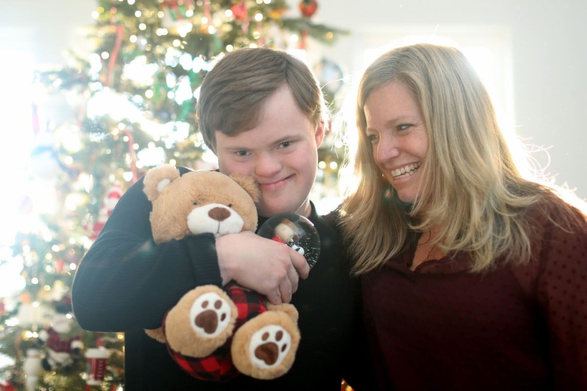 Ben Carnes and his mother, Julie Carnes, at their home. Friends and neighbours put on a Christmas parade for Ben, who loves parades, outside the Carnes family home because the annual Christmas parade was cancelled due to the Covid-19 pandemic. Photo: TNS
