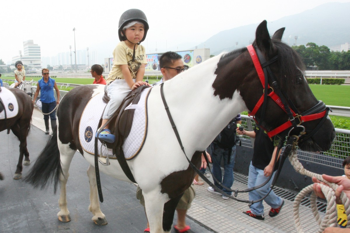 Children enjoy the pony rides during a preseason carnival at Sha Tin racecourse. Photo: Kenneth Chan