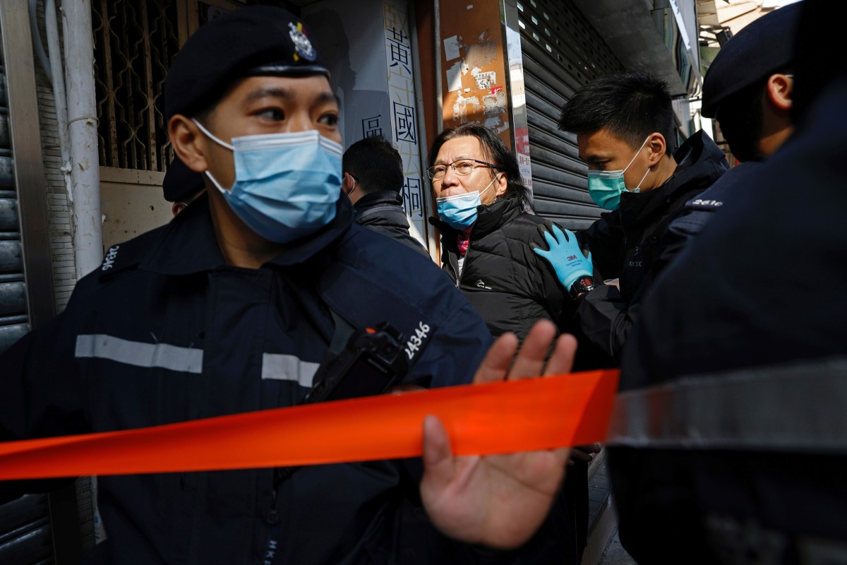 Daniel Wong Kwok-tung, a lawyer who tried to help the 12 people detained in mainland China, is escorted by police as he returns to his office. Photo: Reuters