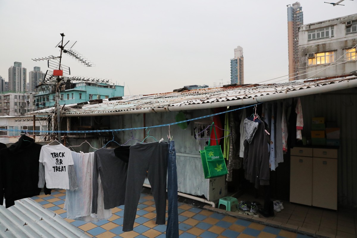 The Lams’ shack, on the right, is on the roof, where other building residents hang their clothes to dry. Photo: K. Y. Cheng