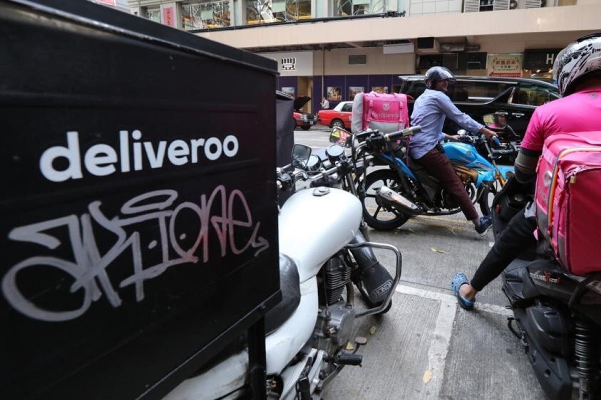 Delivery workers from Deliveroo and Foodpanda park in Wan Chai. Photo: SCMP/ Felix Wong