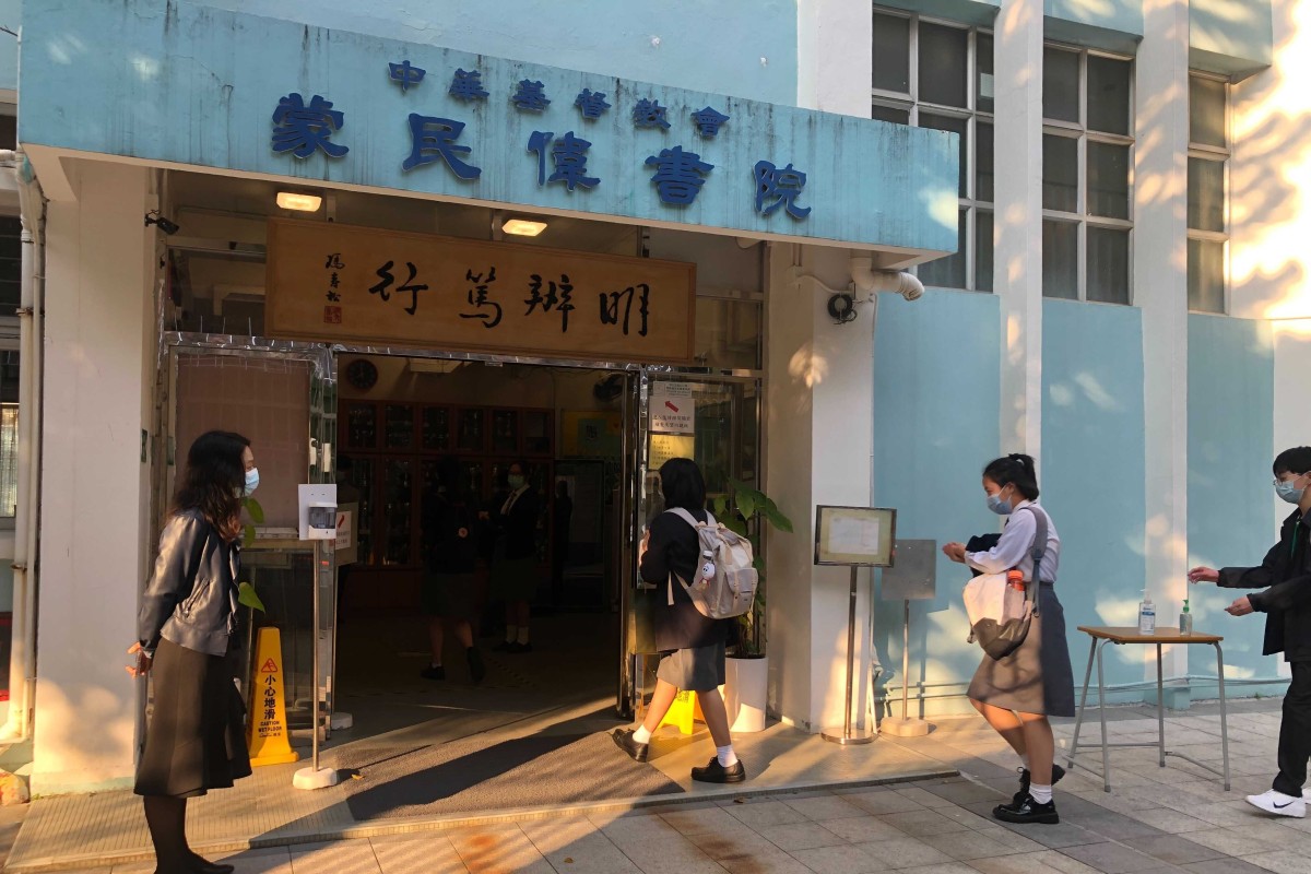 Students from CCC Mong Man Wai College have their temperature recorded and their hands sanitised before entering school. Photo: SCMP/Kelly Fung