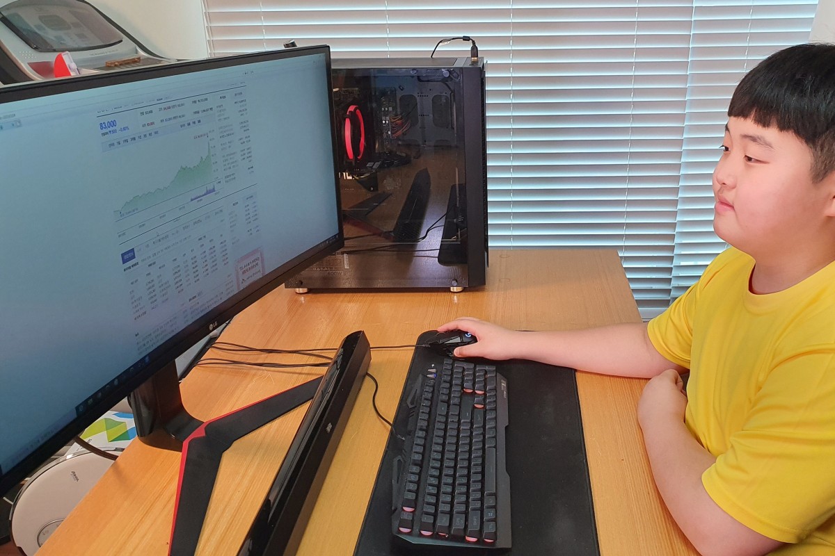Kwon Joon looks at a monitor as he checks investing information in his room in Jeju, South Korea. He got involved in the stock market because he had free time during Covid-19 school suspensions. Photo: Lee Eun-joo/Handout via REUTERS