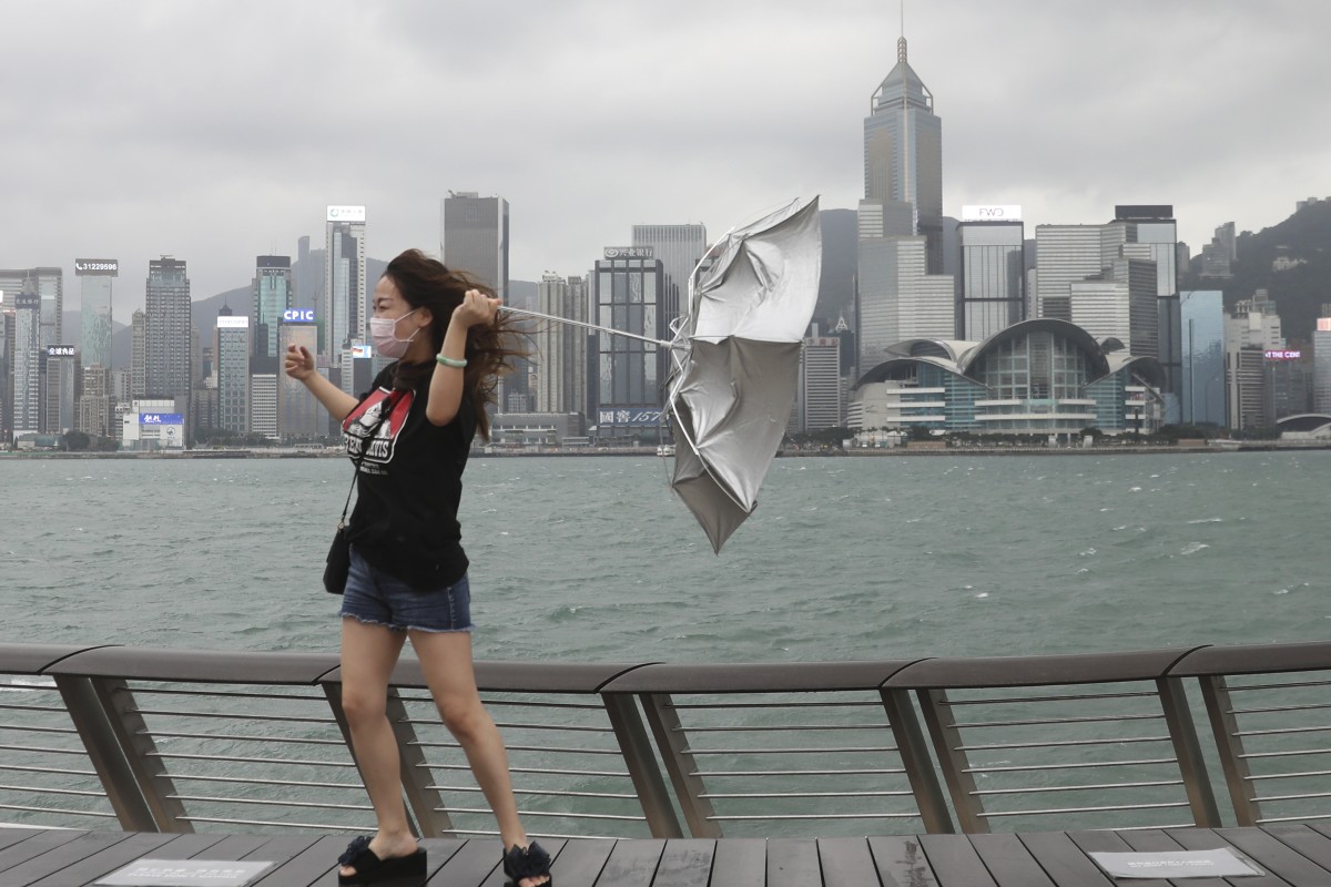 A woman fights against strong winds during a typhoon in Tsim Sha Tsui. Scientists predict storms could be especially severe this year. Photo: SCMP /Winson Wong