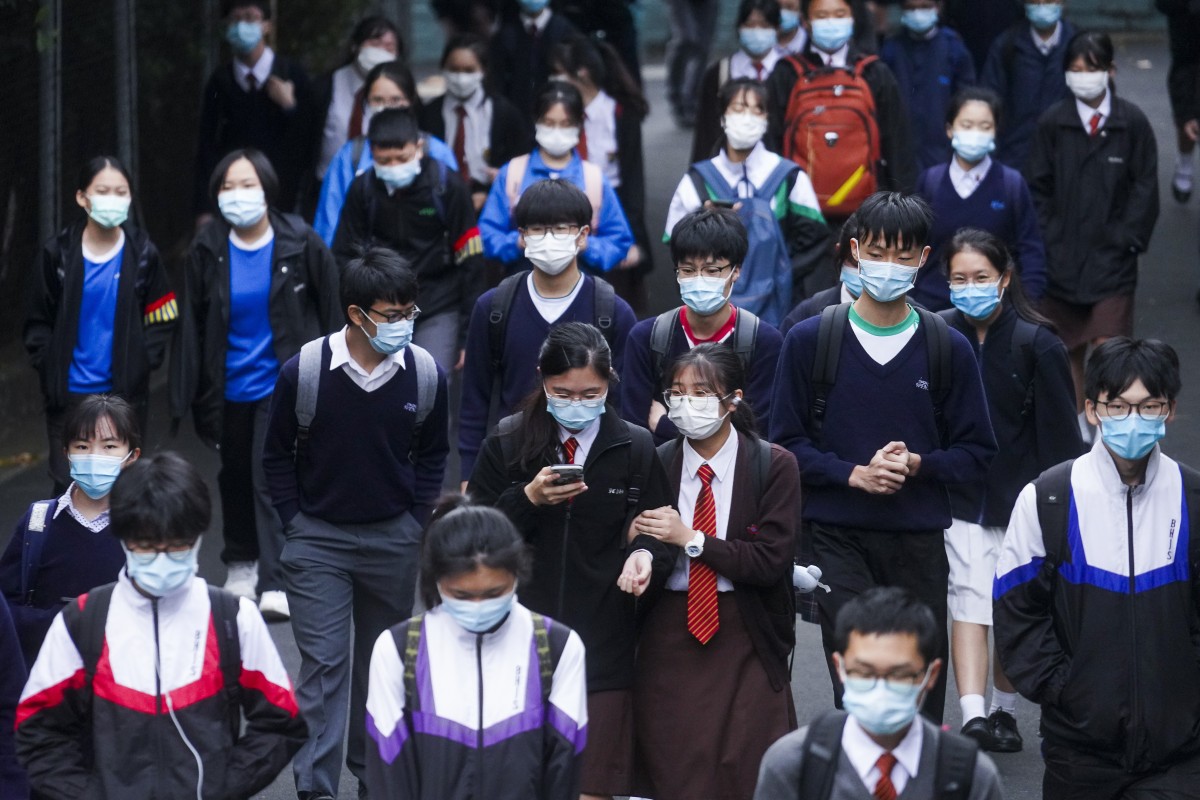 Students wearing face masks attend school in Kowloon Tong. More students will be able to return to campus after the Easter holiday, if the coronavirus situation continues as is. Photo: SCMP/ Winson Wong