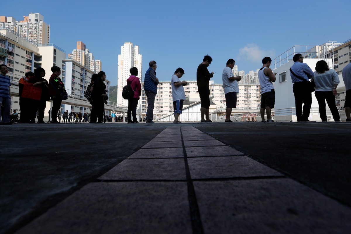 Voters queue at a polling station during district council elections in Hong Kong. Sweeping changes to the electoral system were approved by Beijing today. Photo: Reuters