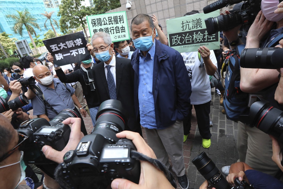 Former lawmaker Martin Lee Chu-ming (left) and "Apple Daily" founder Jimmy Lai Chee-ying appear at West Kowloon Magistrates' Court. Photo: SCMP / Felix Wong