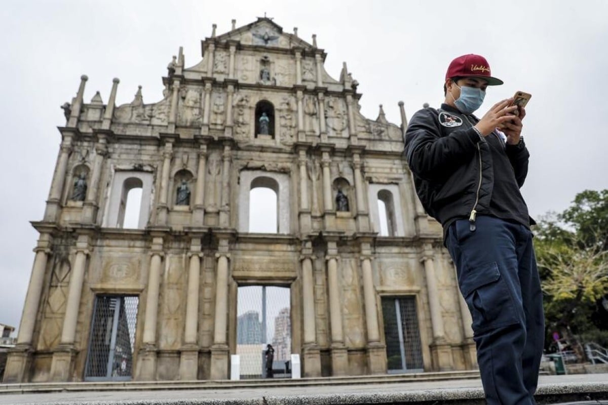 A man stands in front of the Ruins of Saint Paul's Cathedral in Macau. While the gambling hub is open to visitors from mainland China, it has reservations about forming a travel bubble with Macau. Photo: SCMP/Winson Wong