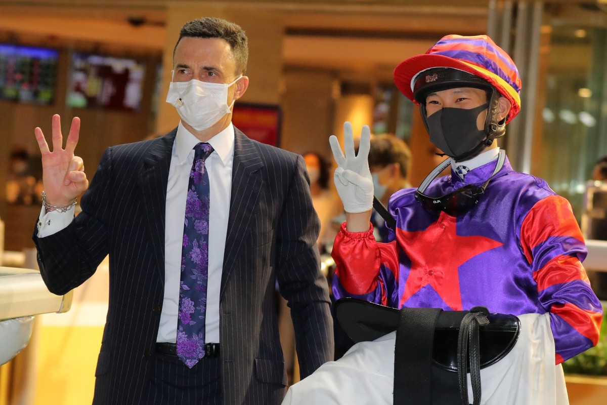 Douglas Whyte and Jerry Chau celebrate their trebles at Happy Valley on Wednesday night. Photo: Kenneth Chan