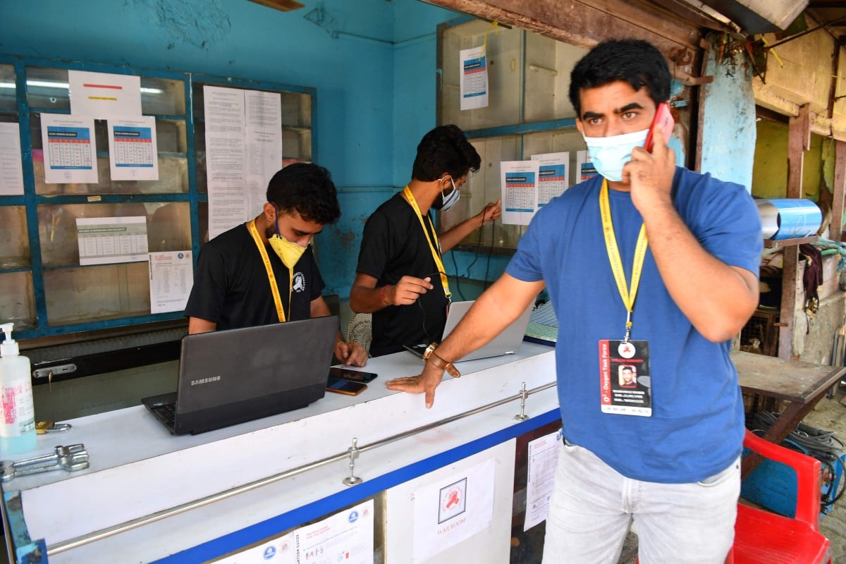 Shanawaz Shaikh speaks on the phone at an oxygen distribution centre in a slum in Mumbai. Photo: Agence France-Presse