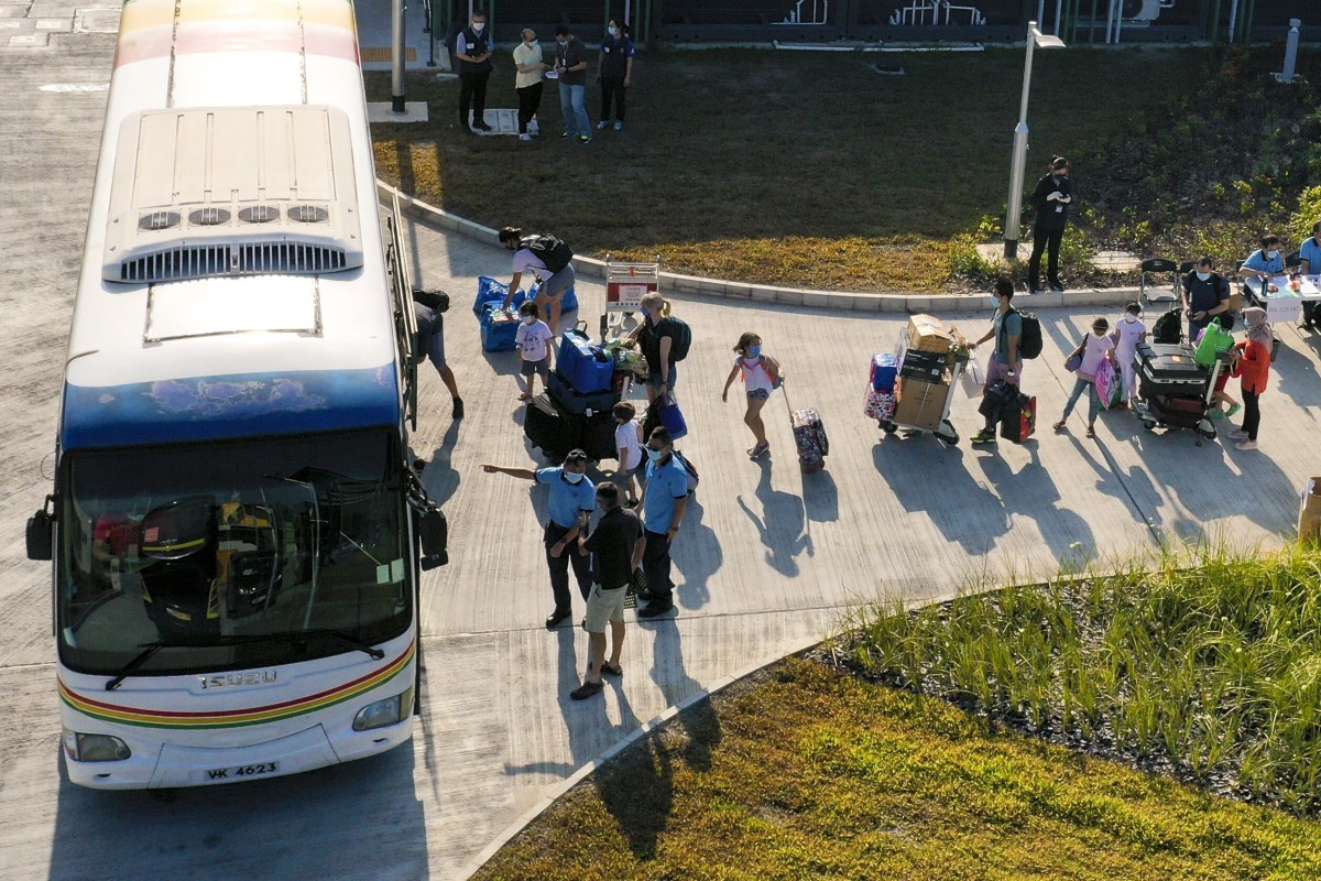 People leave Penny's Bay government centre. Is it fair for a whole building to quarantine due to one positive coronavirus case? Photo: SCMP/Nora Tam