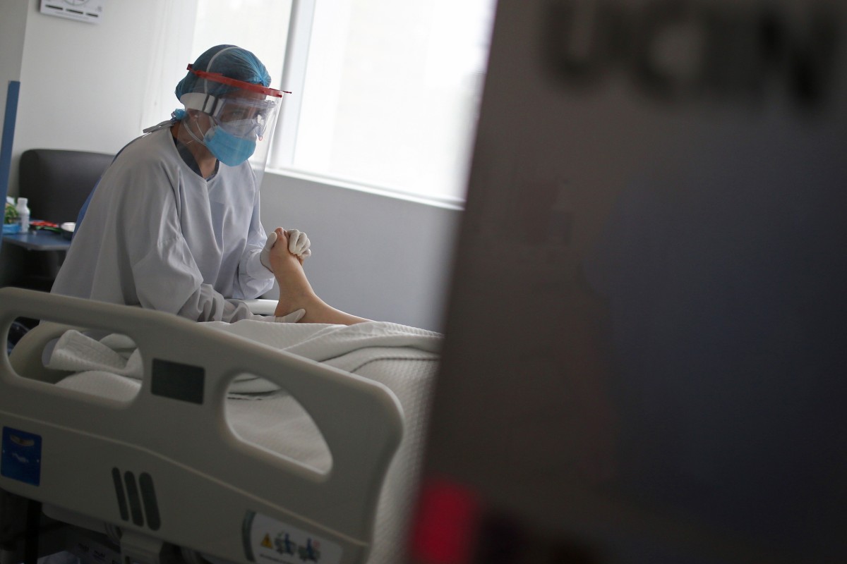 A healthcare worker provides care for a patient with Covid-19 in the Intensive Care Unit at the Clinica Nueva El Lago, in Bogota, Colombia. Photo: Reuters